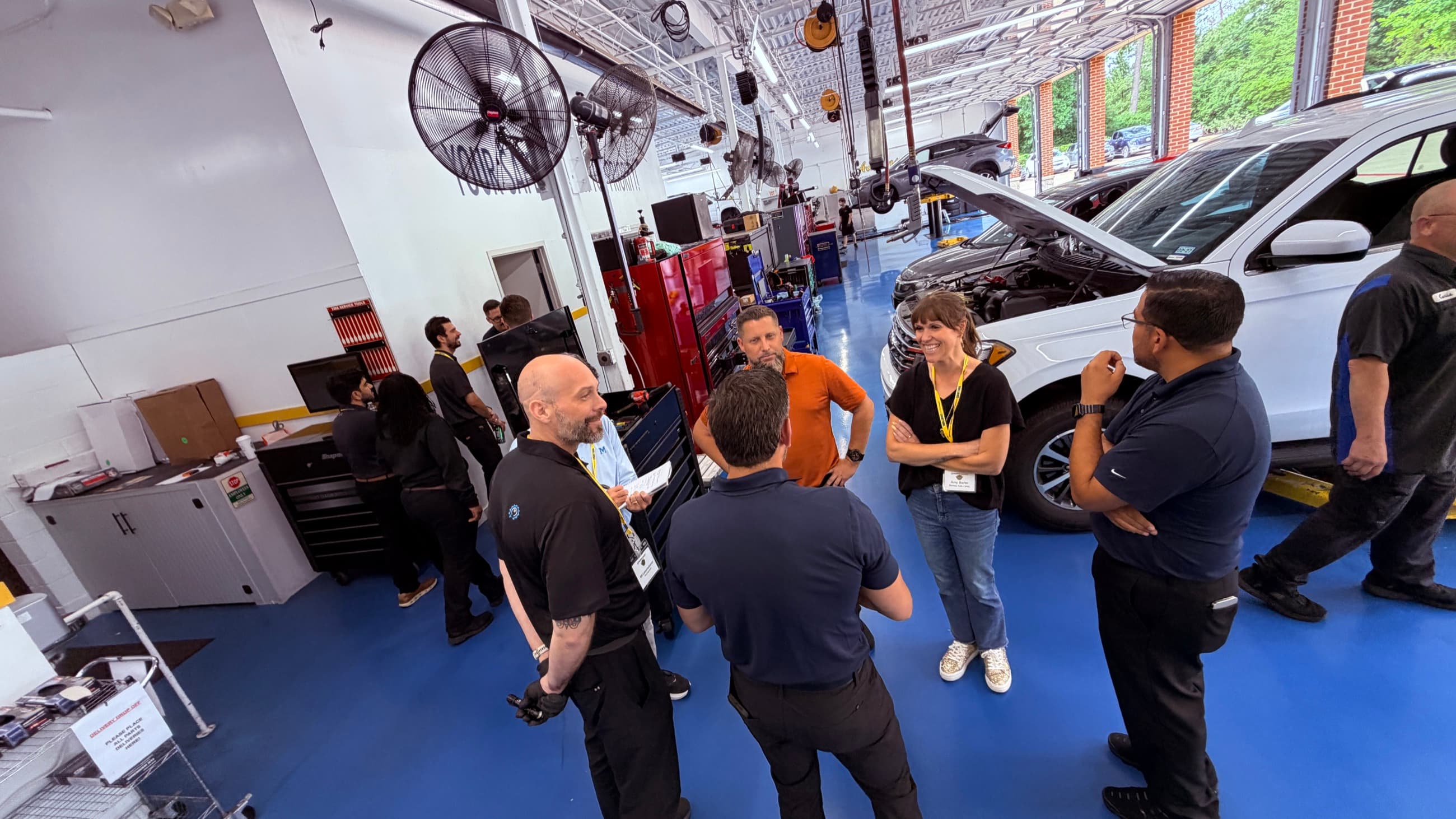 Shop leaders discussing an operating process on the service floor